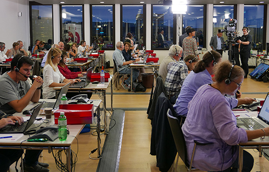 Volunteers at the telephone centre in Zurich take donation pledges over the phone.